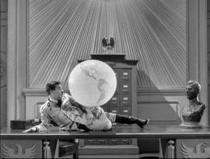 Adenoid Hynkel (Charlie Chaplin) holding a globe of the world.